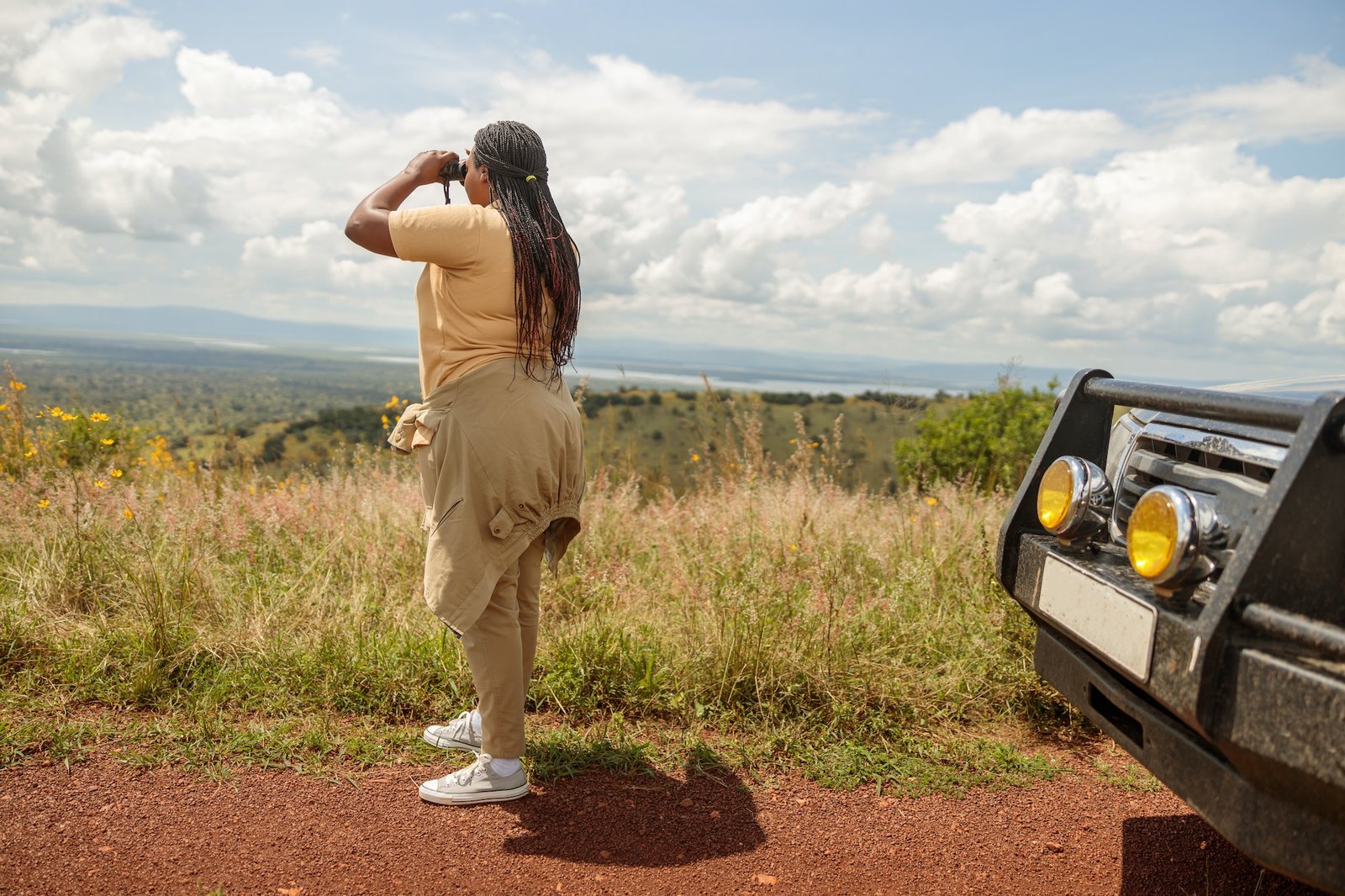 Safari and Kenya Wildlife Tours - Female guide using binoculars Magical Exploits Safaris