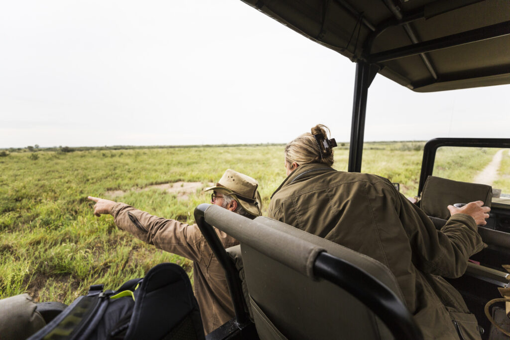 Tourists viewing lions in Masai Mara